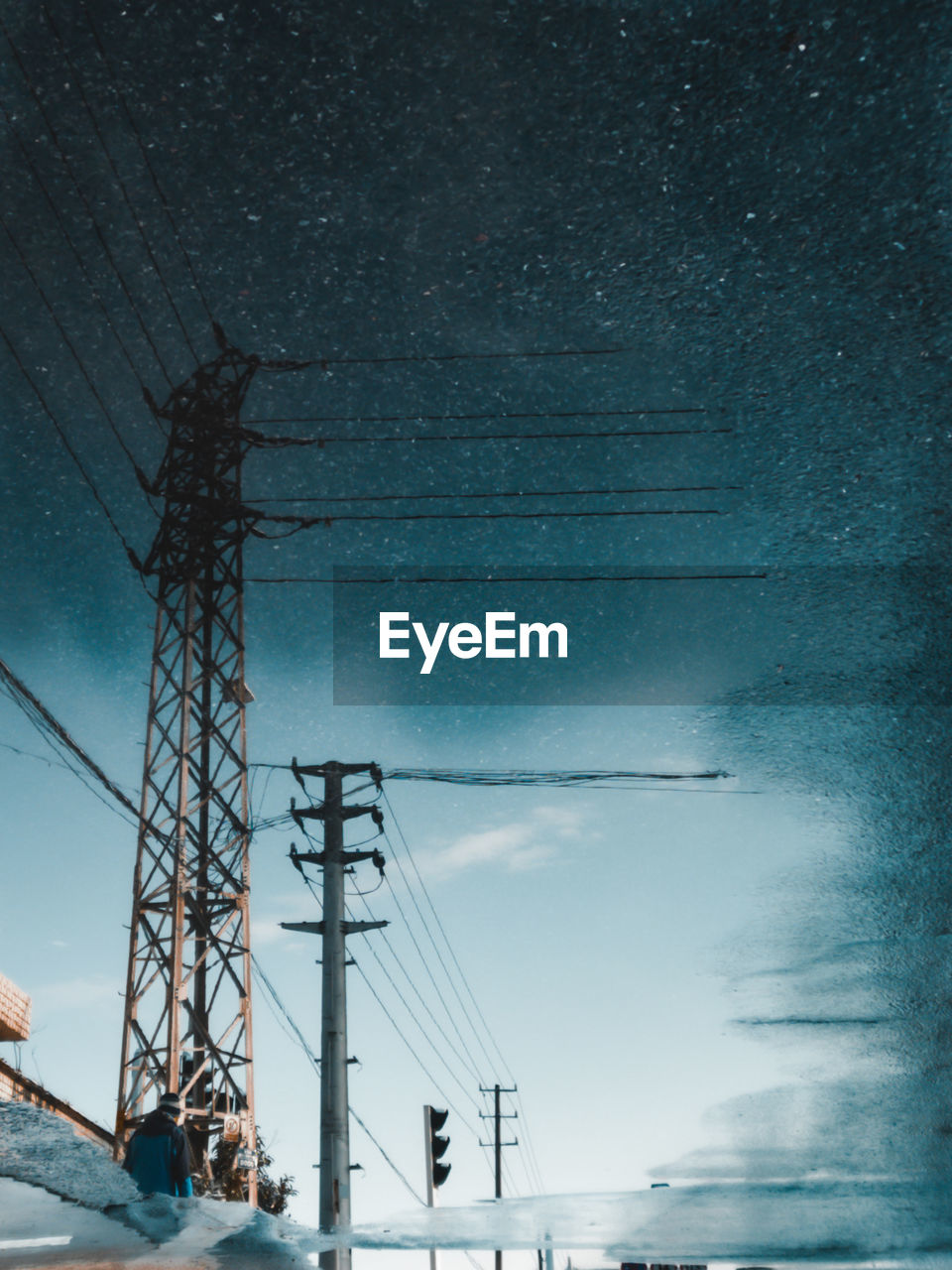 LOW ANGLE VIEW OF ELECTRICITY PYLONS AGAINST SKY AT DUSK