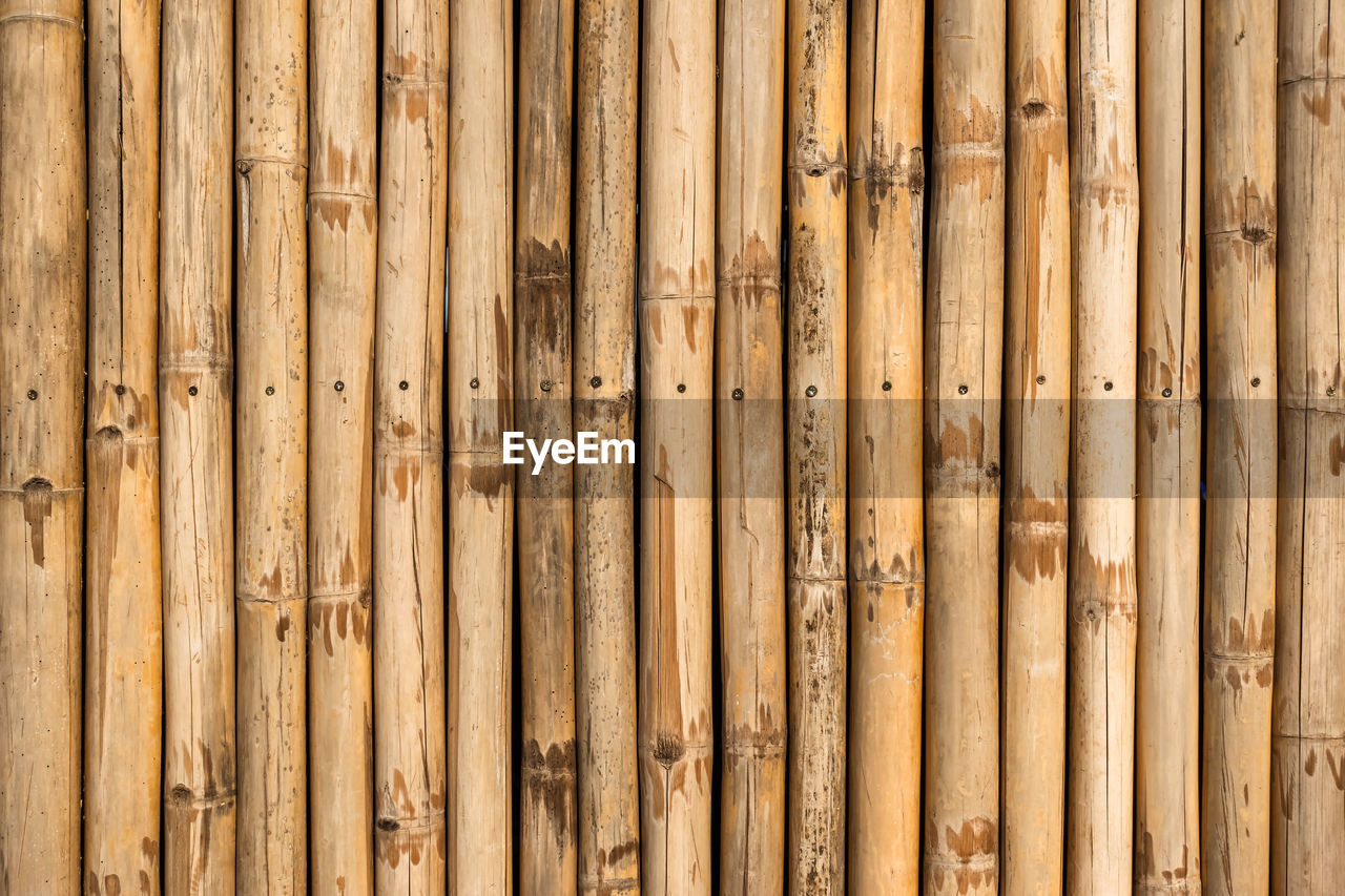 Old brown tone bamboo simple wall or bamboo fence texture background for  design vintage tone. 