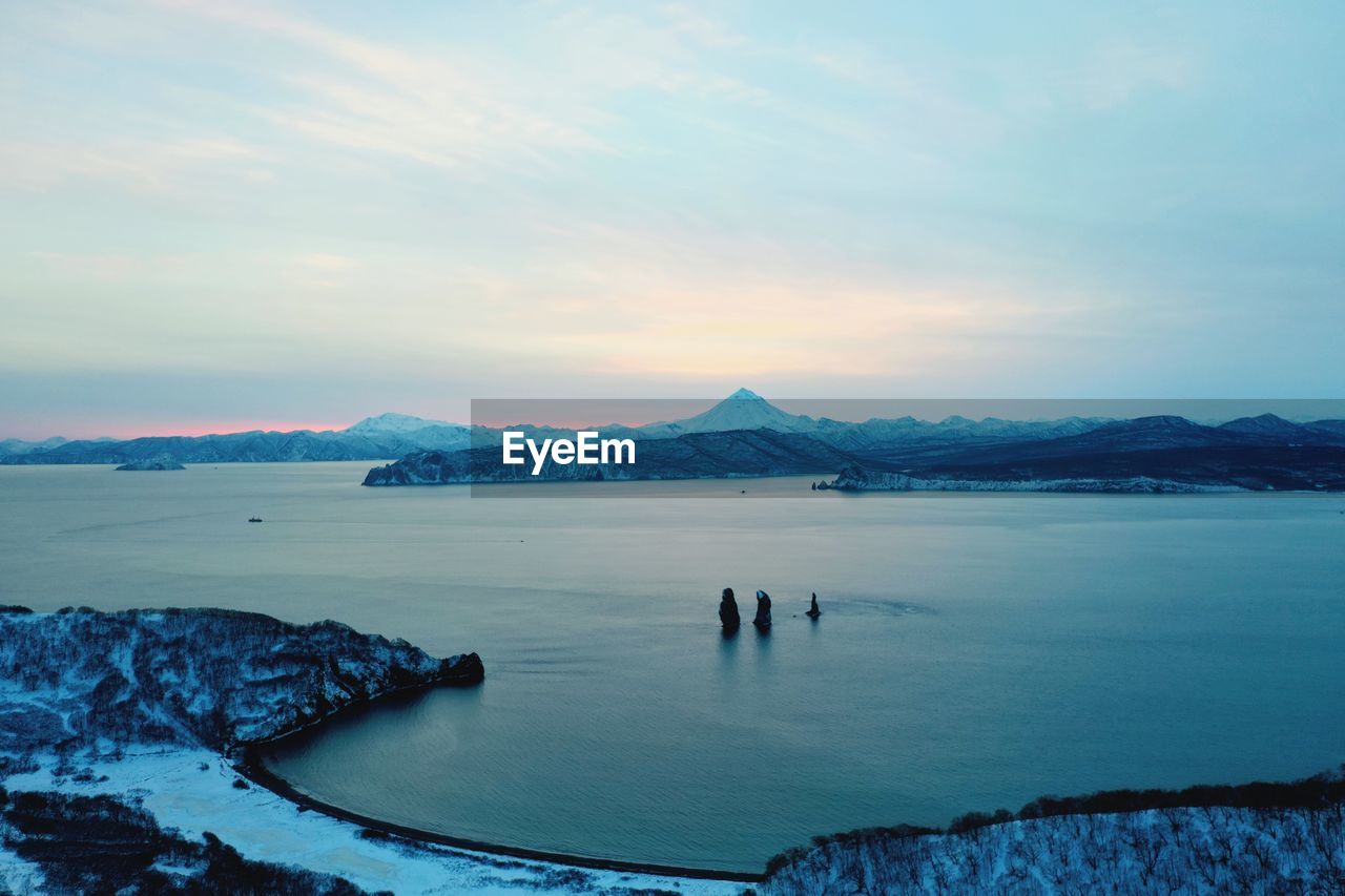 Scenic view of sea against sky during winter