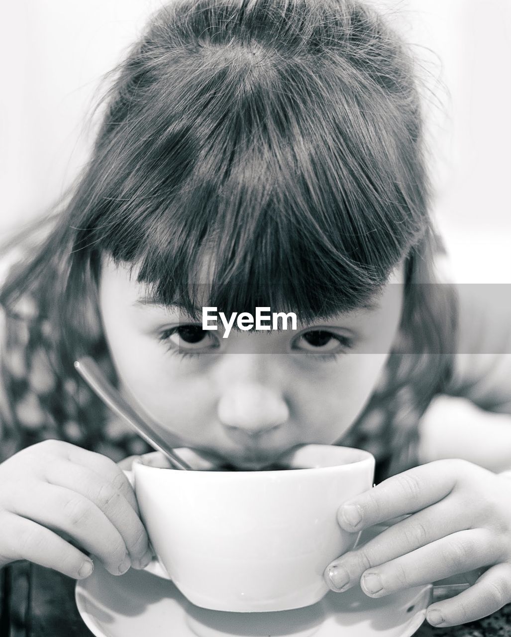 CLOSE-UP OF A BOY DRINKING WATER FROM