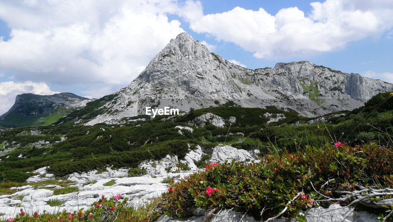 Scenic view of mountains against cloudy sky