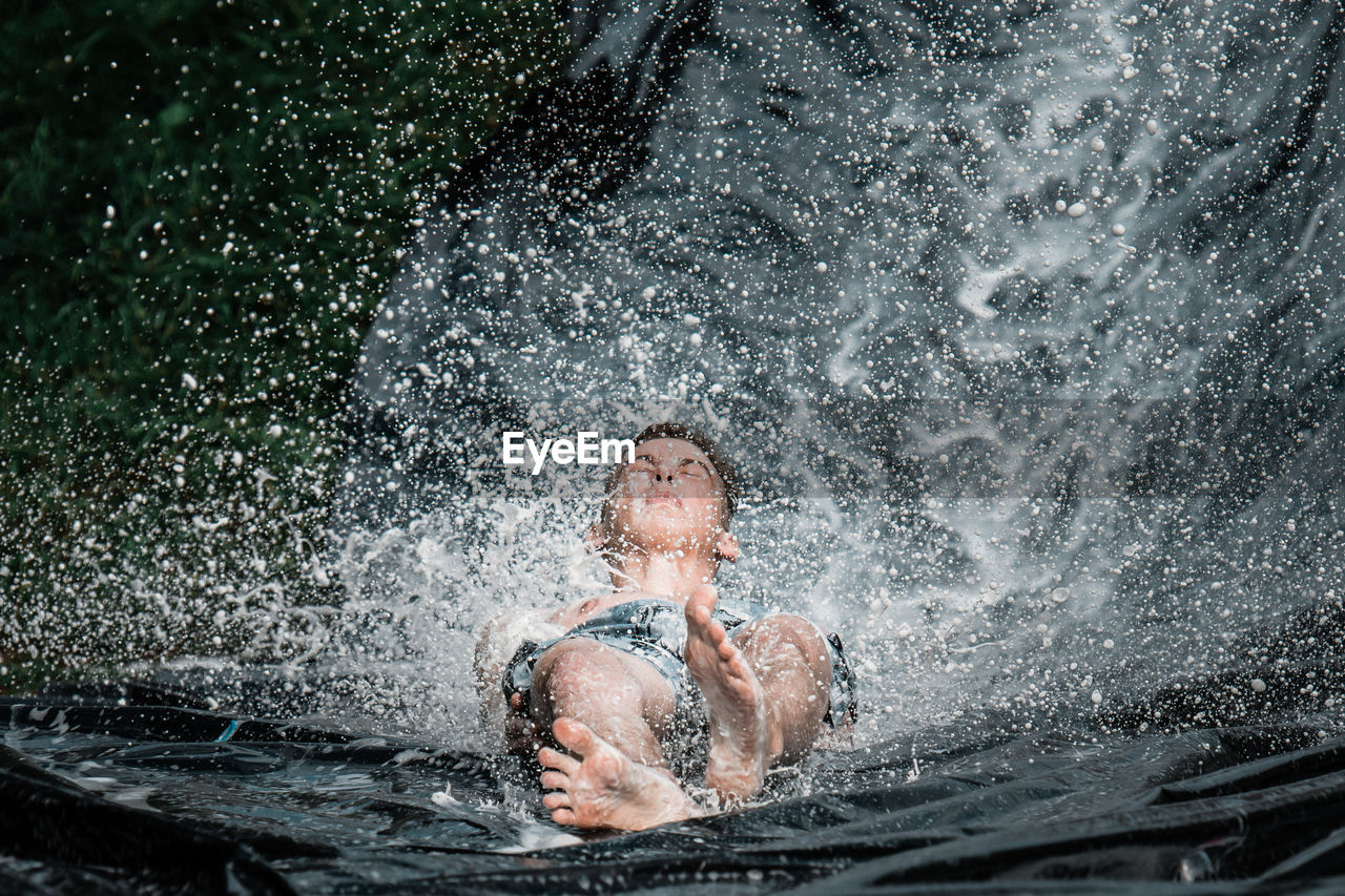 PORTRAIT OF SHIRTLESS MAN IN WATER