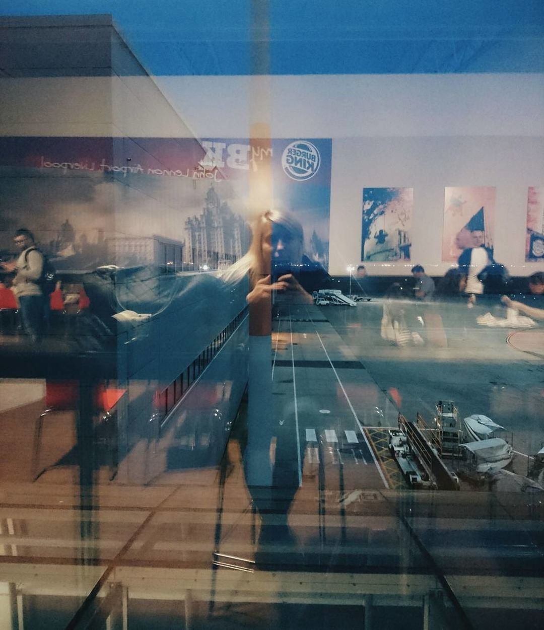 REFLECTION OF WOMAN ON MIRROR IN OFFICE