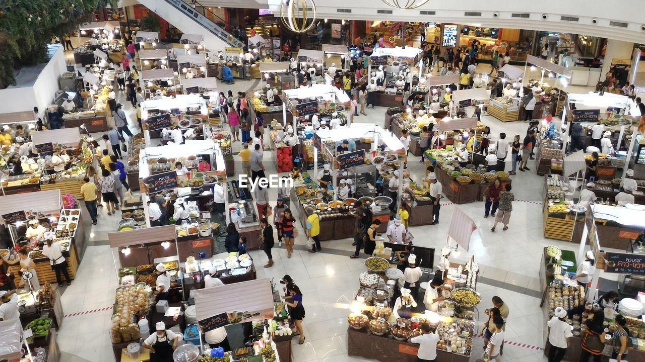 PEOPLE AT MARKET STALL