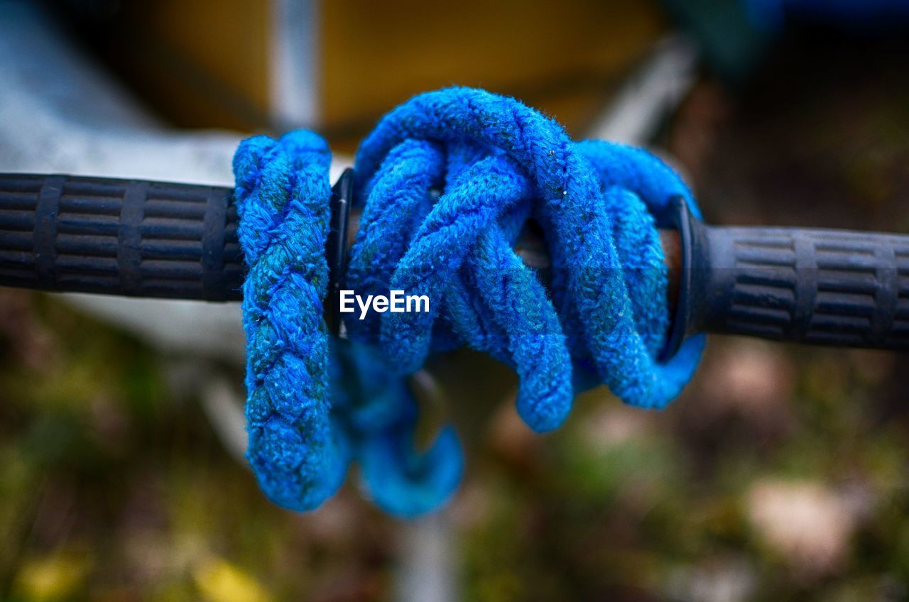 Close-up of blue ropes tied to handle