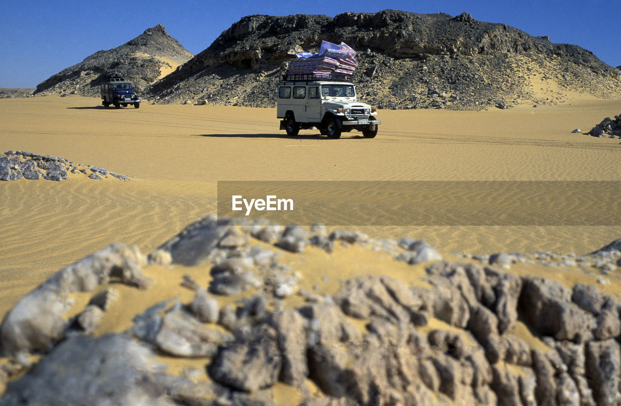 Land vehicles on desert landscape