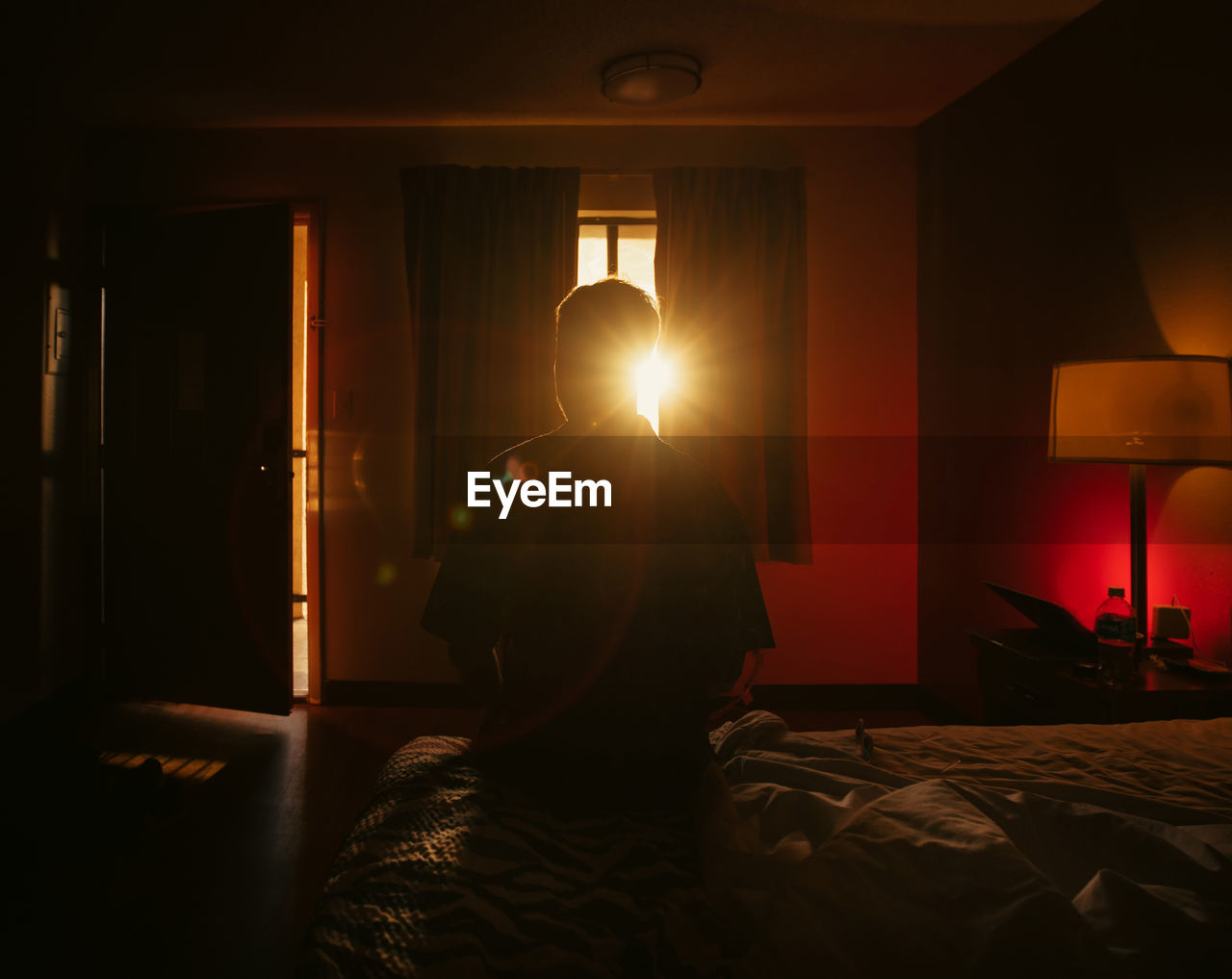 rear view of woman standing in hotel room