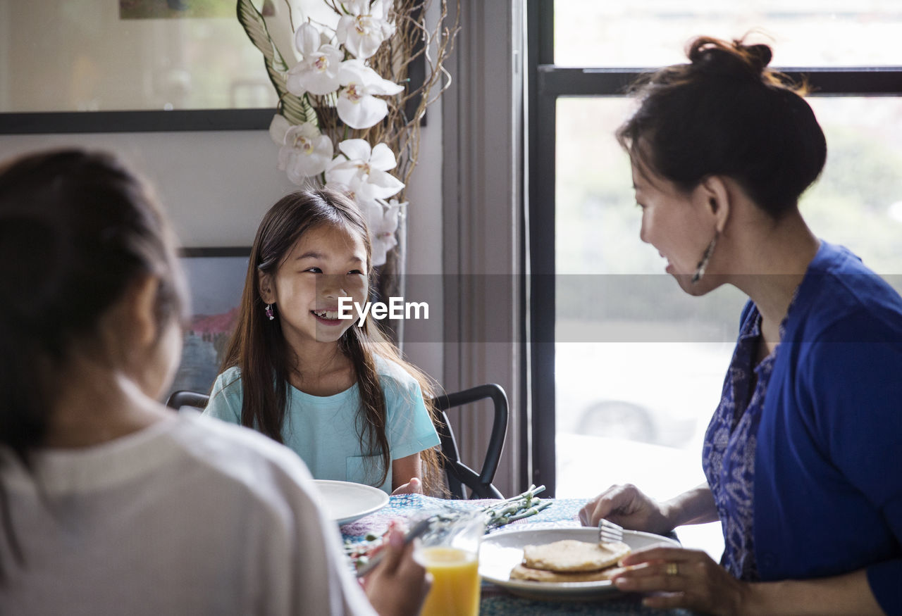 Family enjoying breakfast at home on birthday