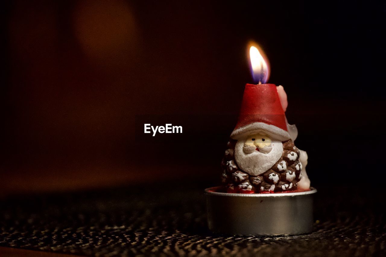 Close-up of illuminated candles on table