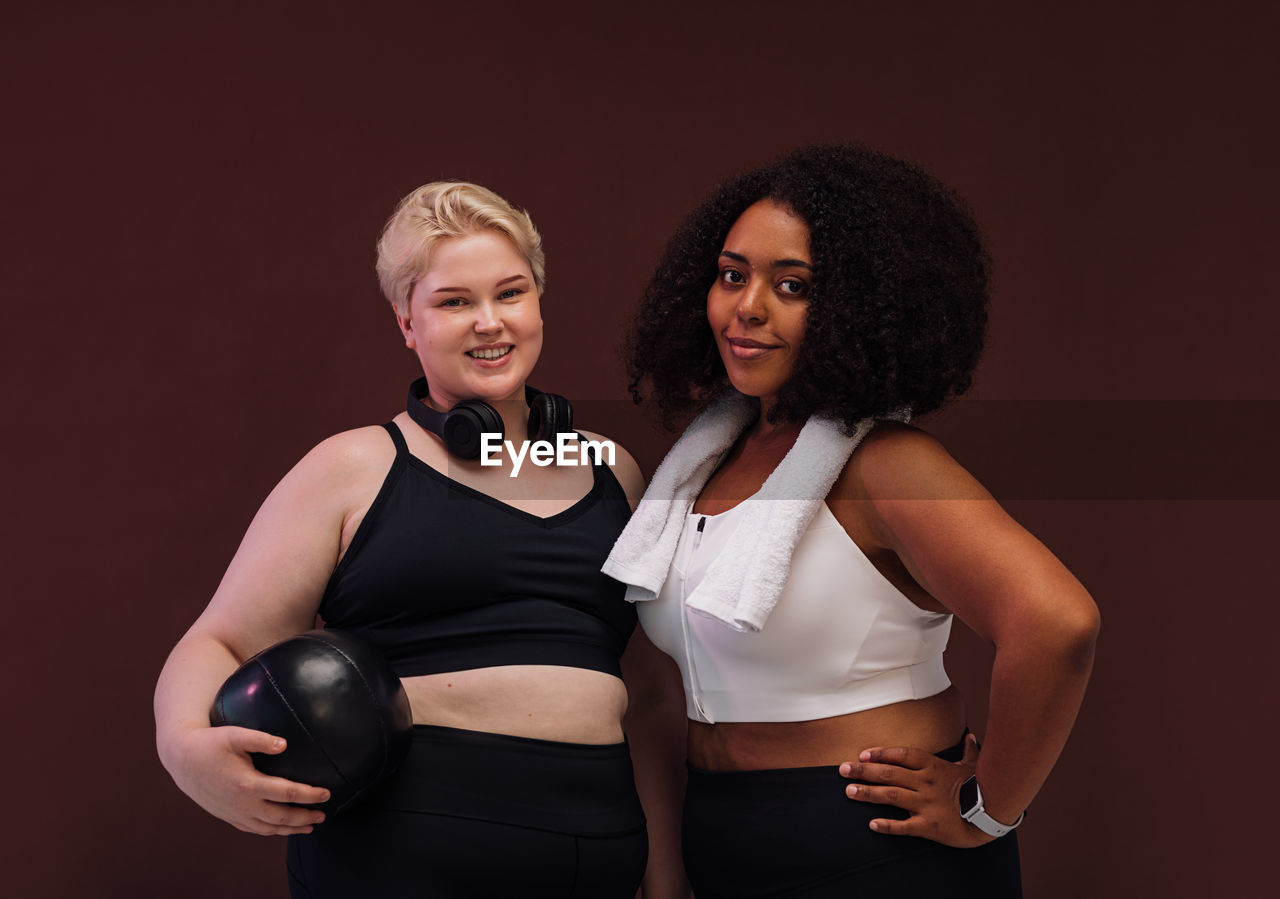 Portrait of females against brown background