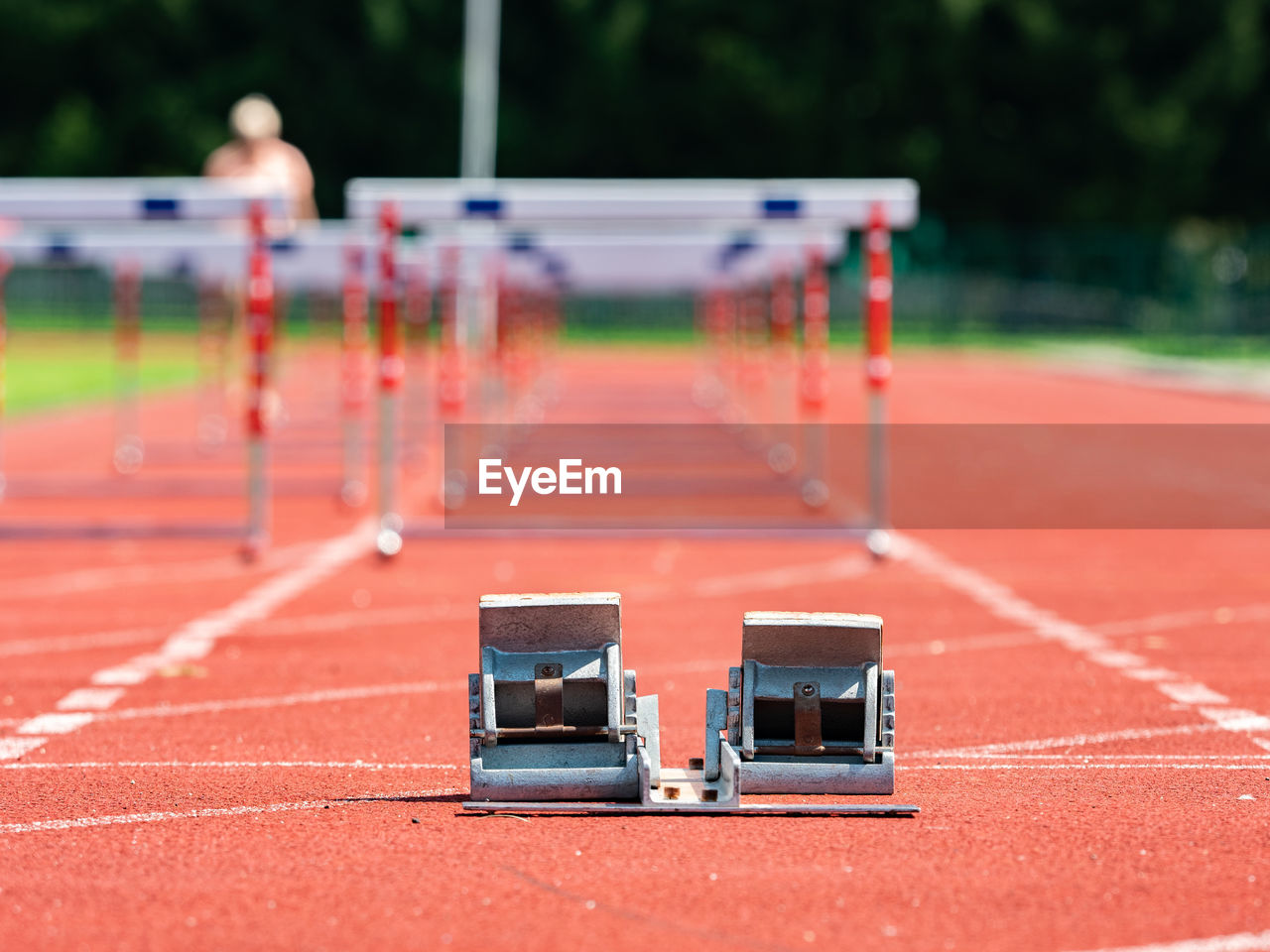 Obstacle course training. athletics starting blocks and red running tracks in a stadion