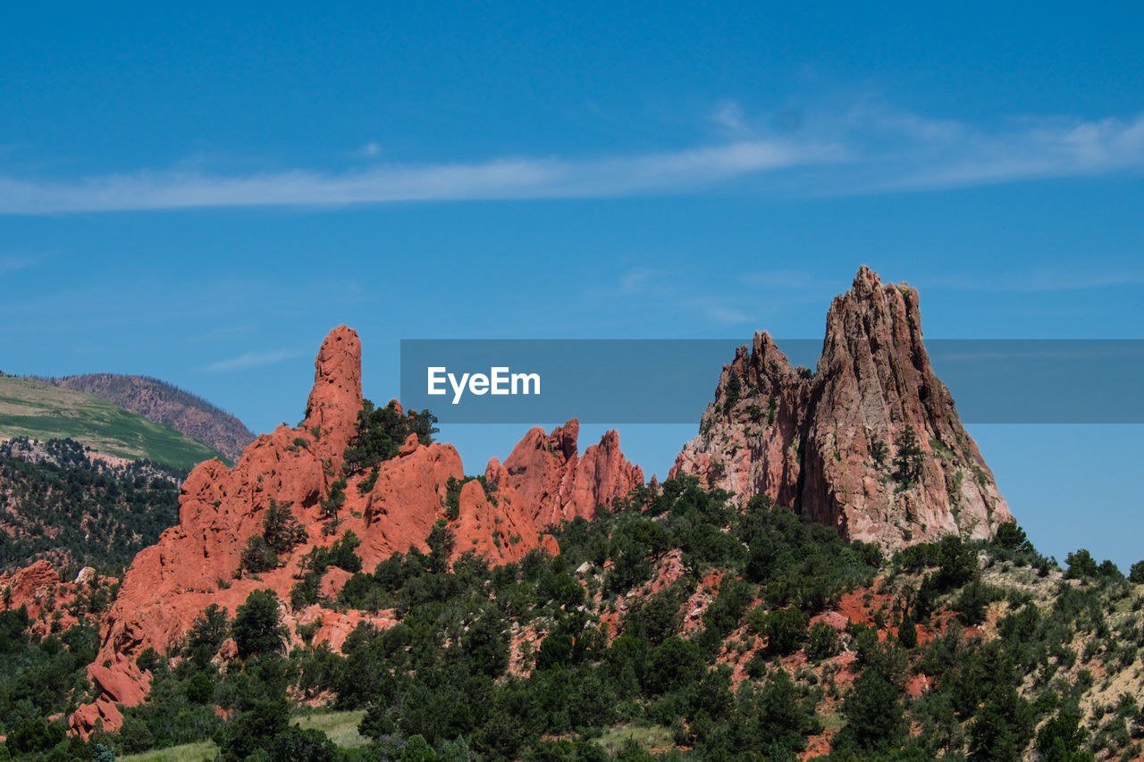 Scenic view of mountain against blue sky