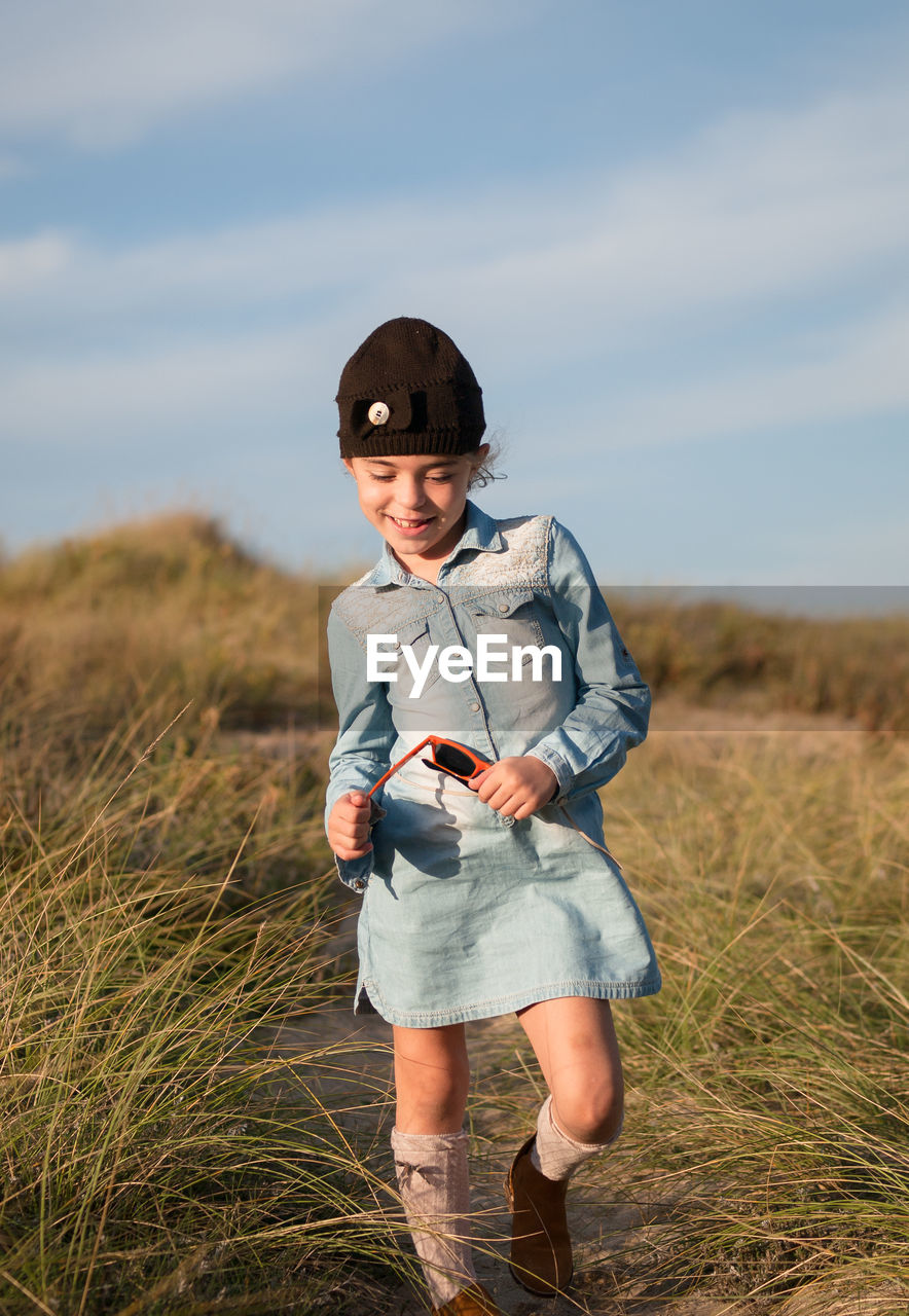 Full length portrait of boy standing on field