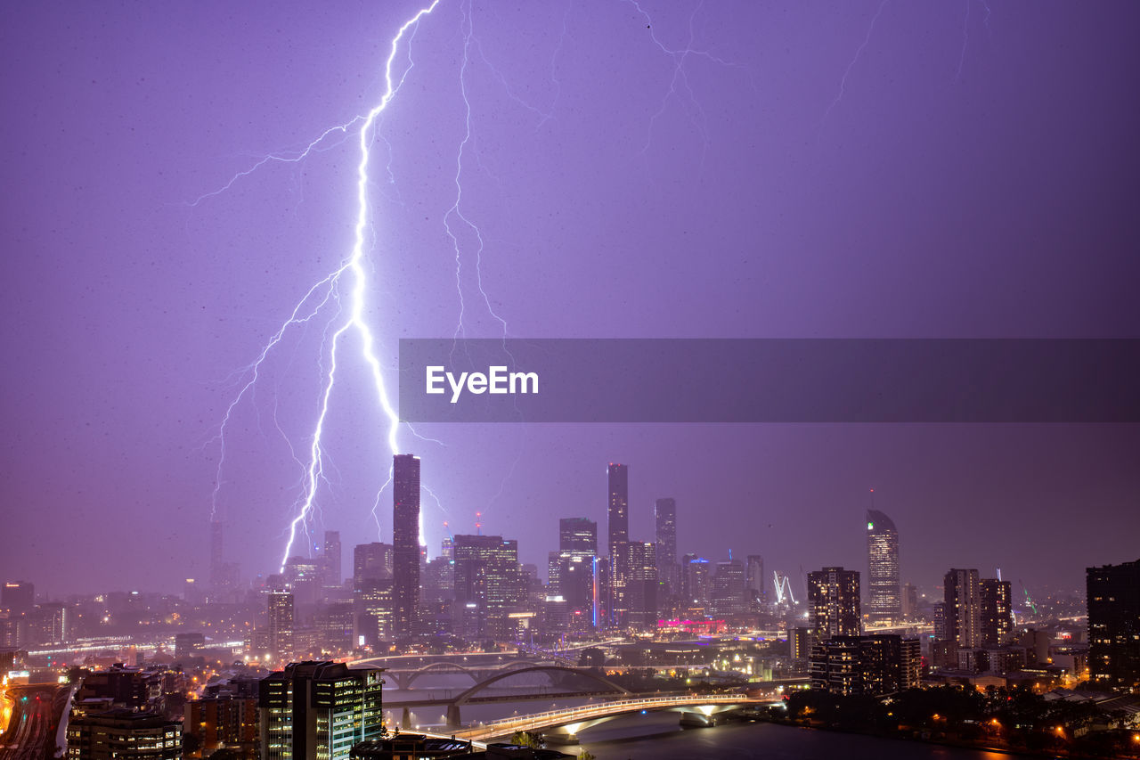 Aerial view of illuminated city against sky at night