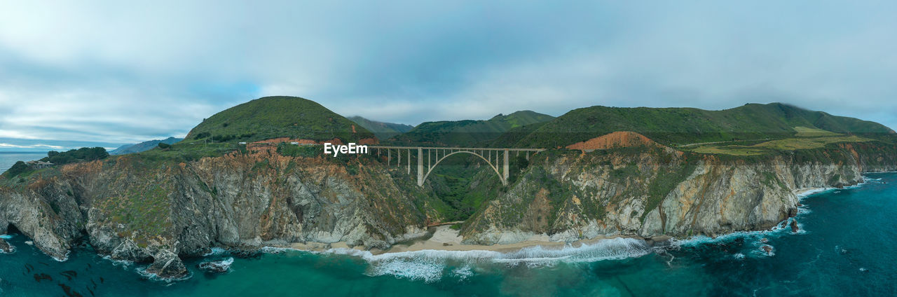 Panoramic view of bridge over sea against sky