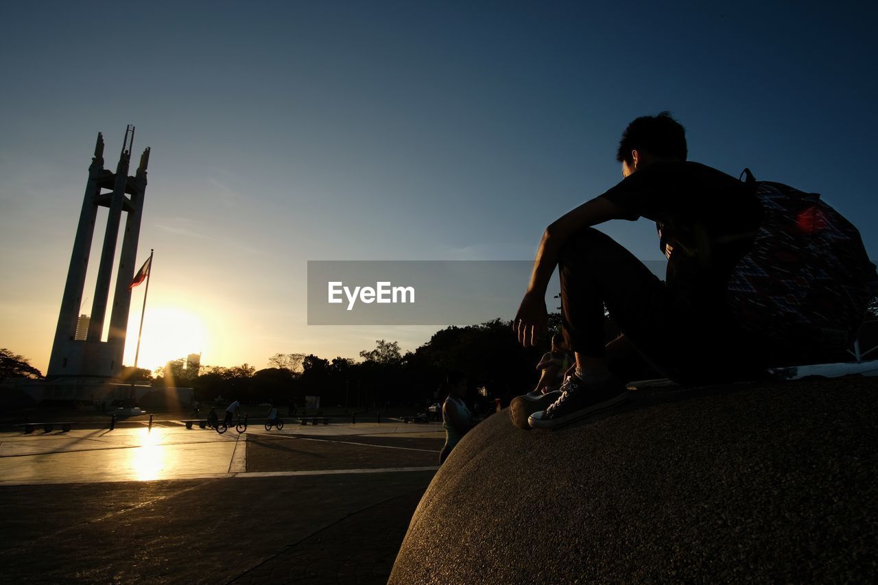 MAN SITTING ON ROOF