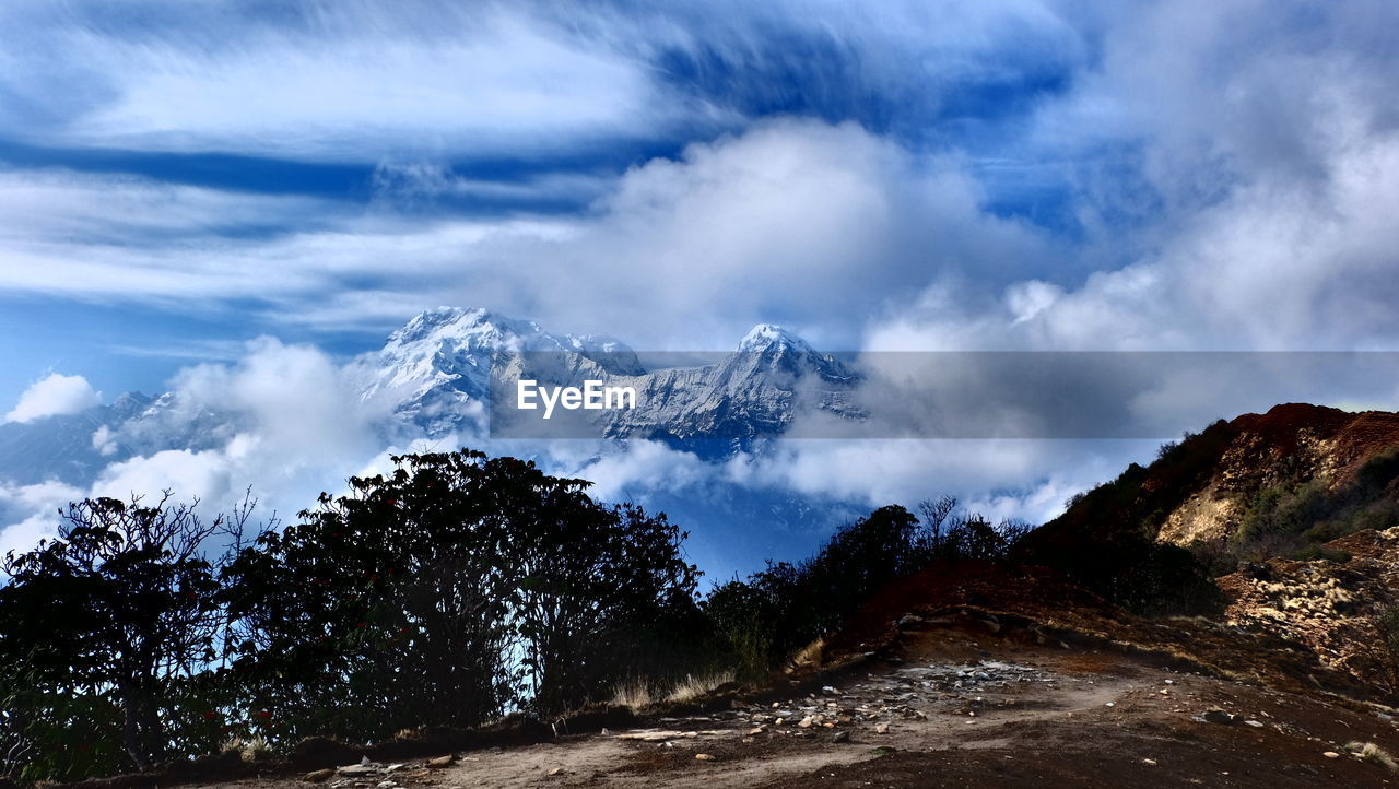 Scenic view of mountains against cloudy sky