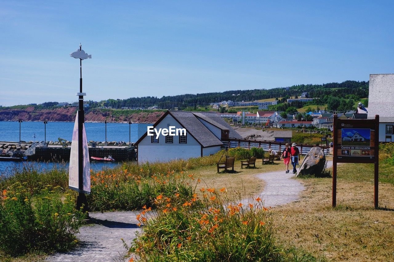 architecture, built structure, water, sky, building exterior, nature, building, walkway, plant, vacation, house, sea, city, beach, travel destinations, day, clear sky, no people, coast, transportation, outdoors, land, blue, town, residential district, street, travel, rural area, tourism, grass, landscape, body of water, beauty in nature