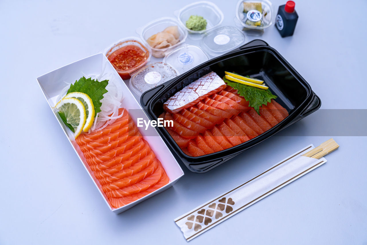 High angle view of salmon sashimi on white background