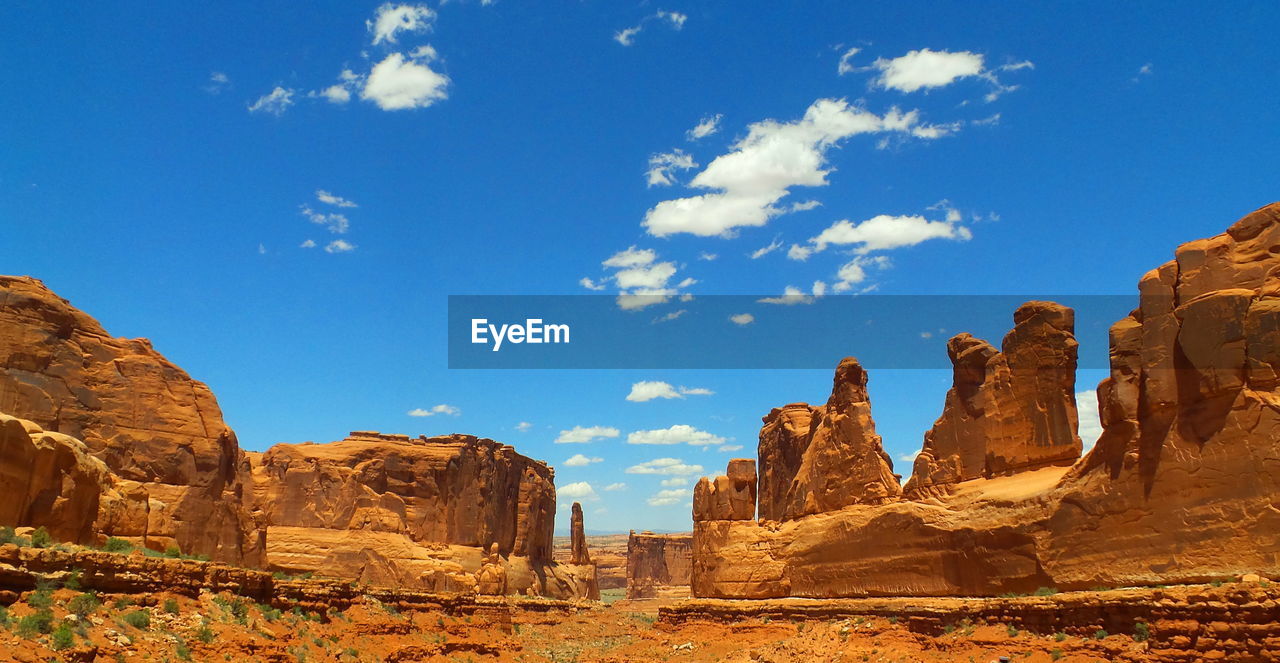 Rock formation against blue sky on sunny day