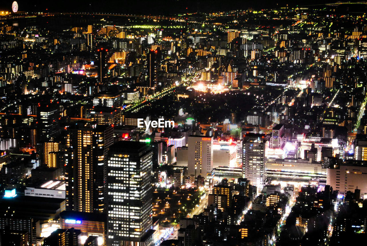 Aerial view of city lit up at night