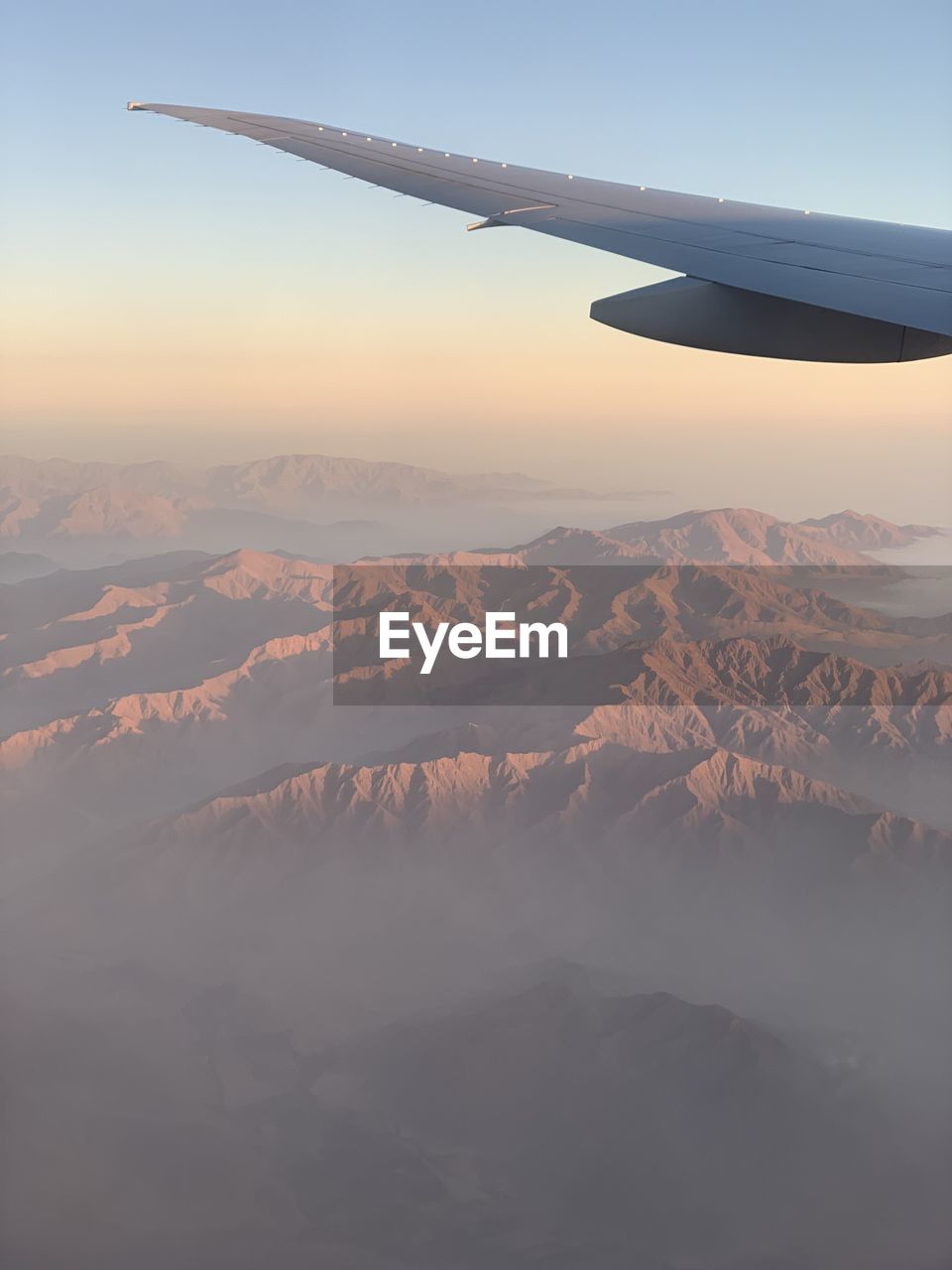 Aerial view of mountain against sky during sunset