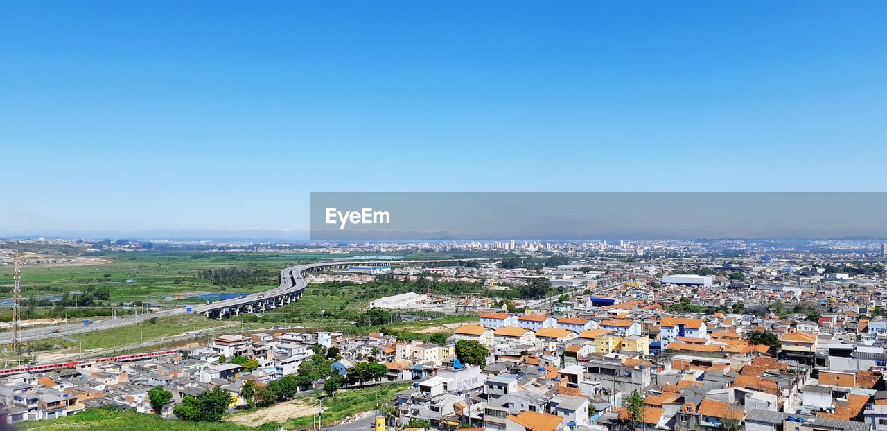 High angle shot of townscape against clear blue sky