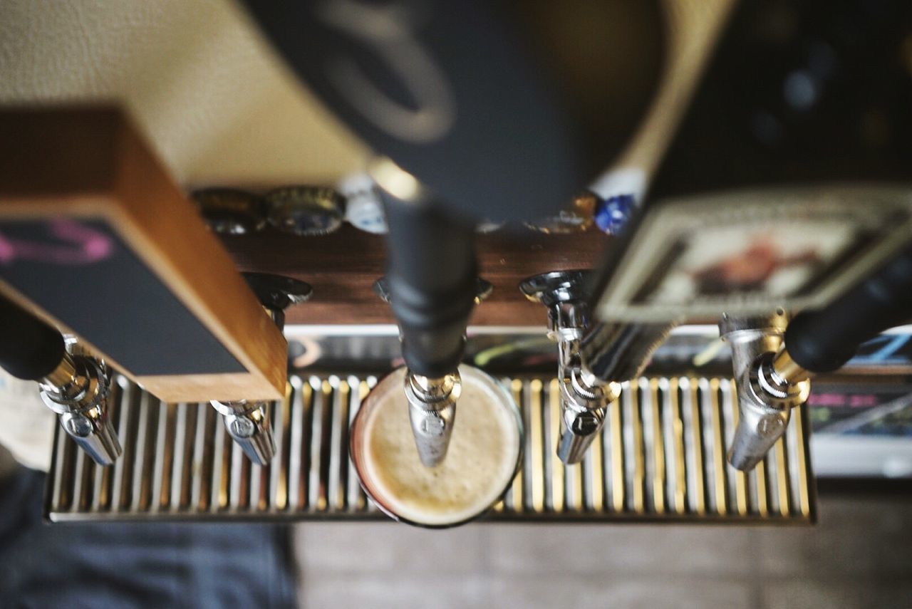 High angle view of brewery beer tap at bar