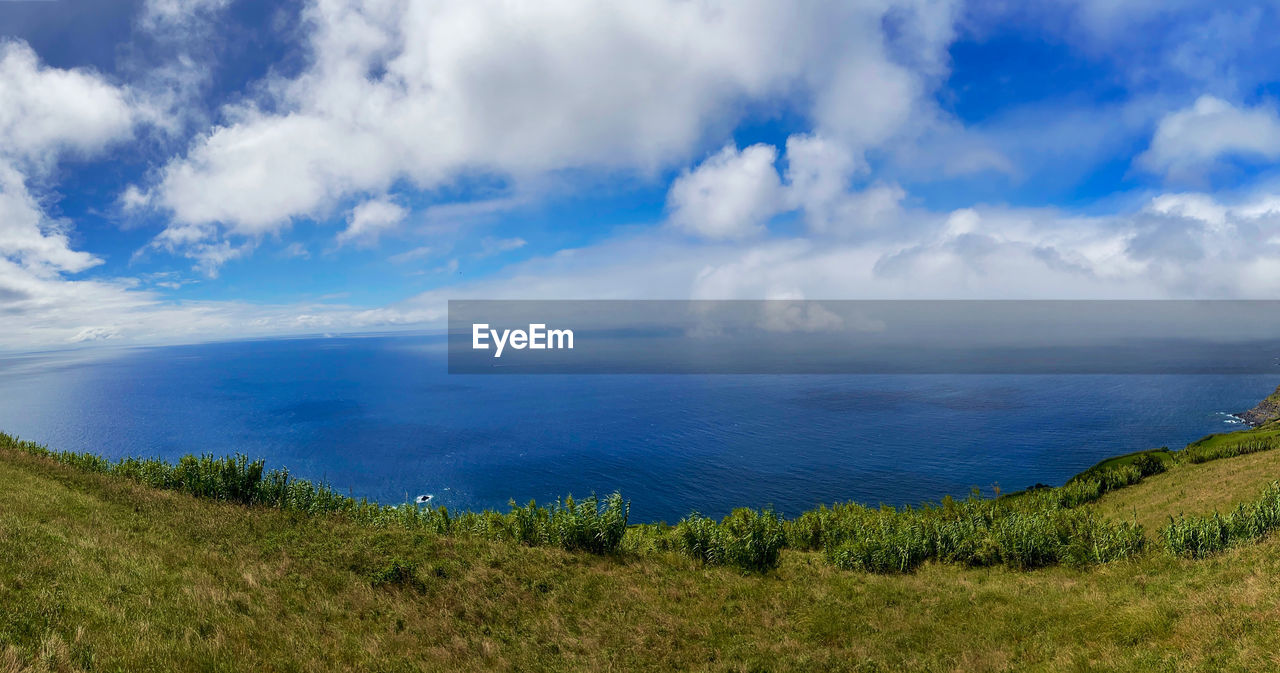 PANORAMIC VIEW OF SEA AGAINST CLOUDY SKY