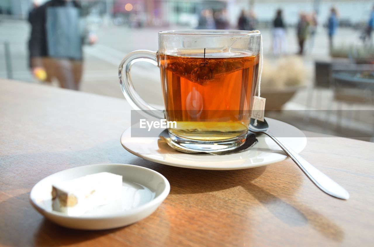 Close-up of tea with sweet food on wooden table