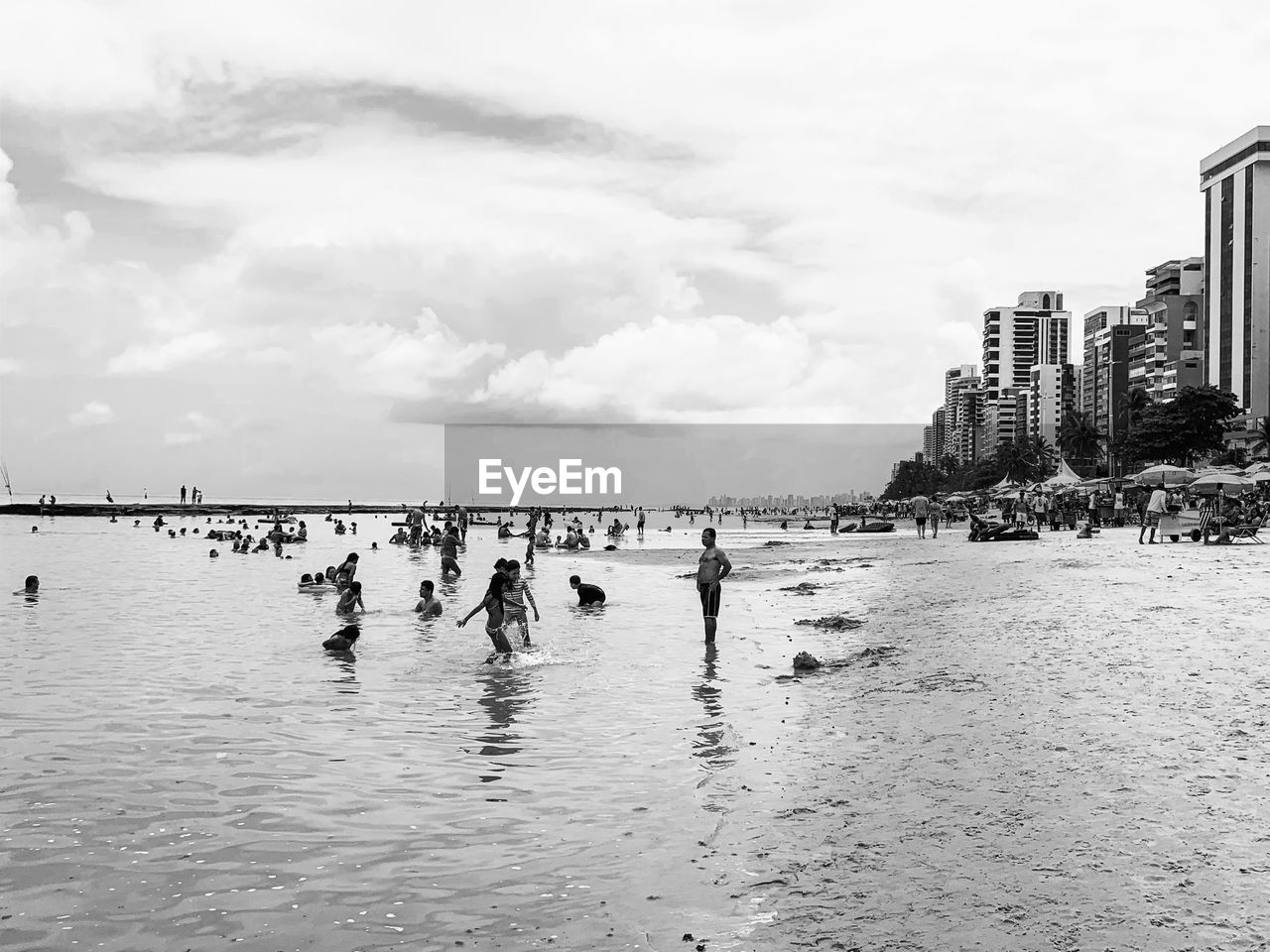 PEOPLE ON BEACH AGAINST SKY