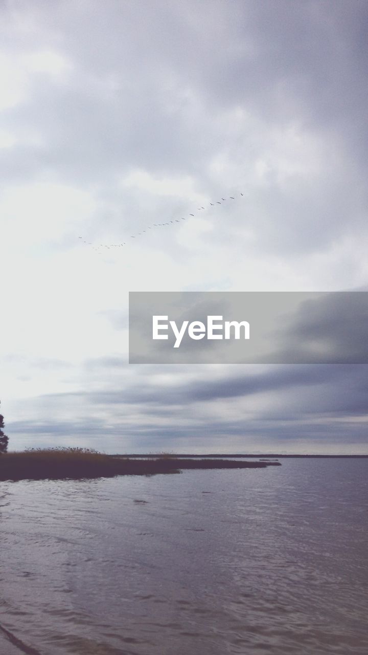 Scenic view of sea against cloudy sky