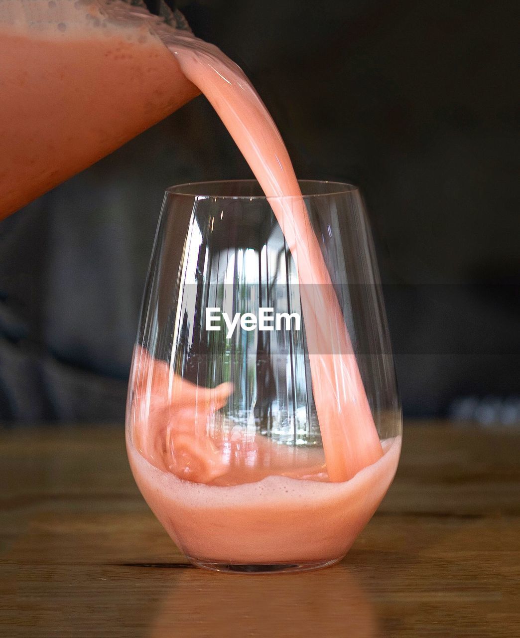 Close-up of juice pouring in glass