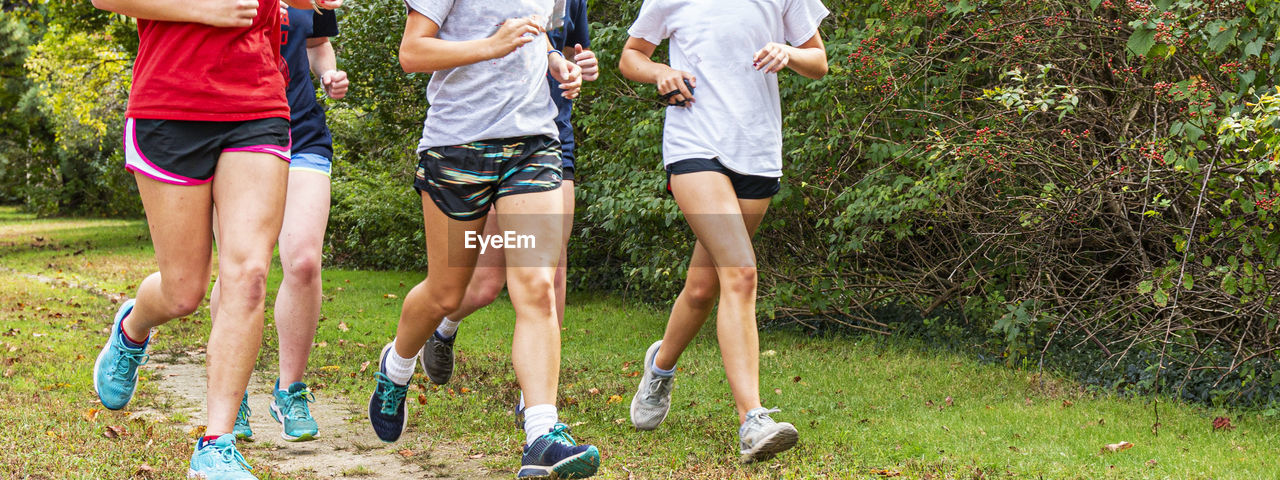 Low section of women jogging at public park