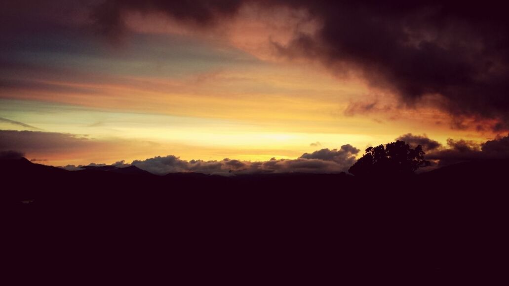 SCENIC VIEW OF MOUNTAINS AT SUNSET