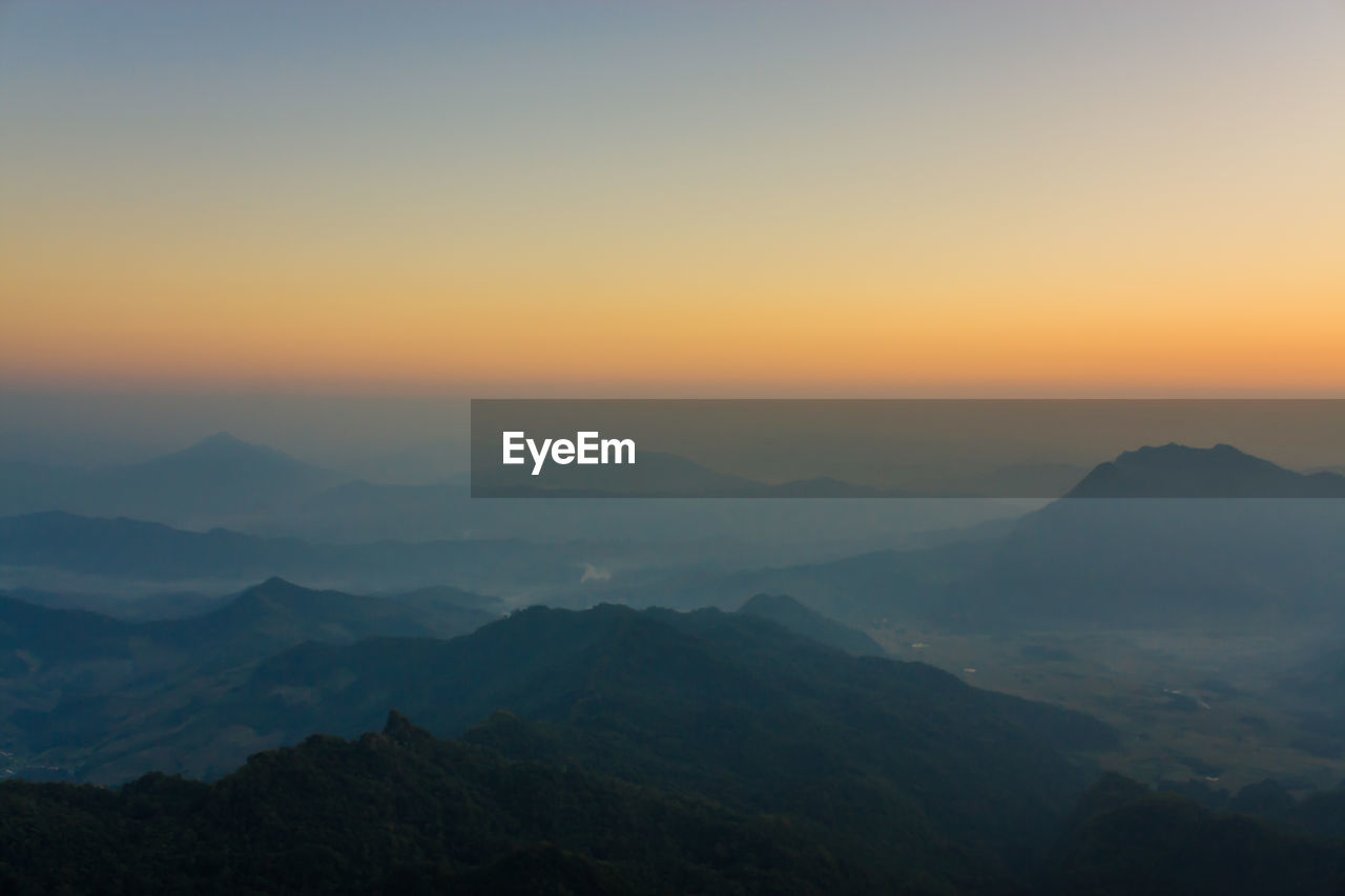 Scenic view of mountains against clear sky during sunset