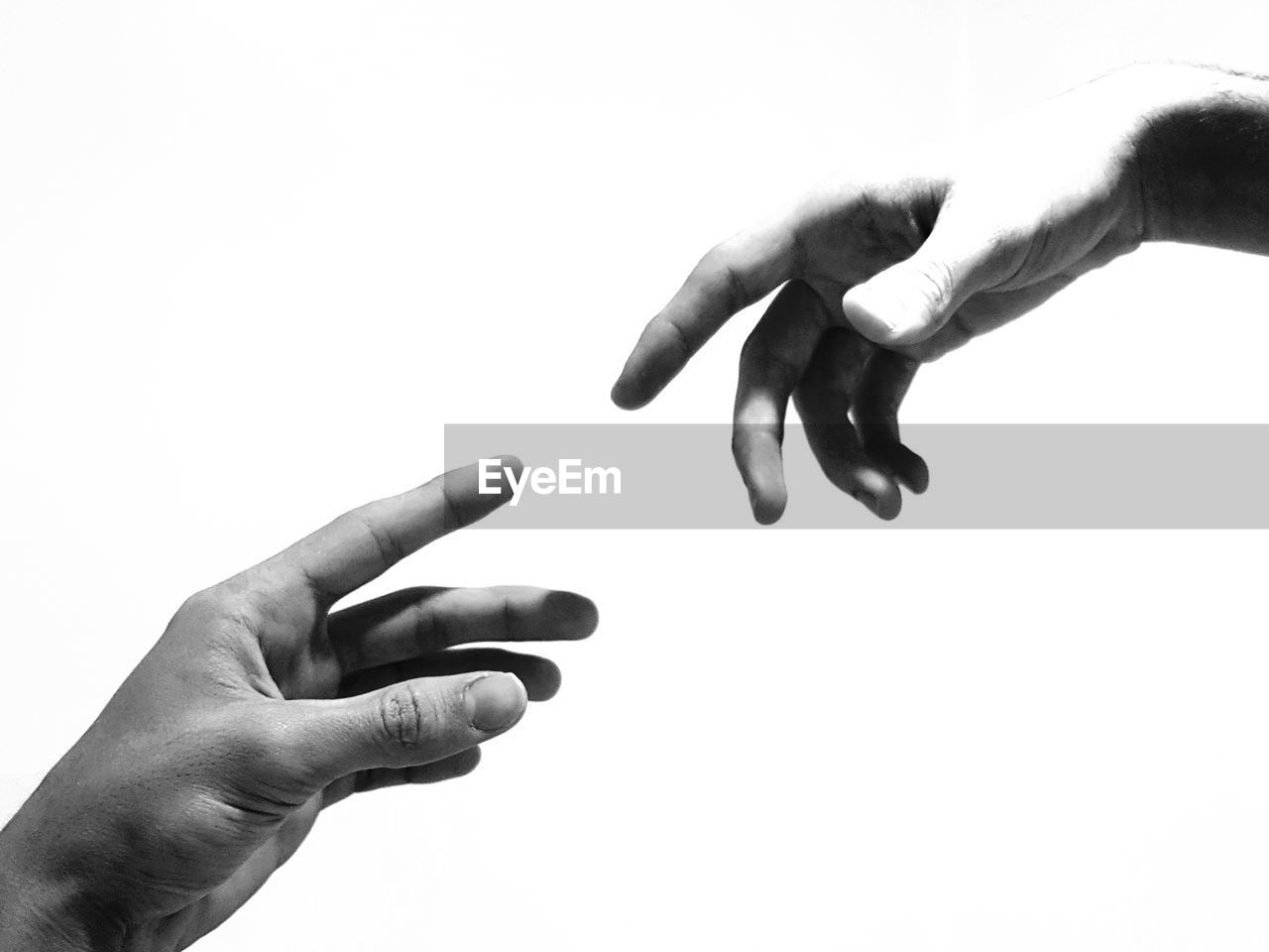 CLOSE-UP OF HAND HOLDING GRAY BACKGROUND