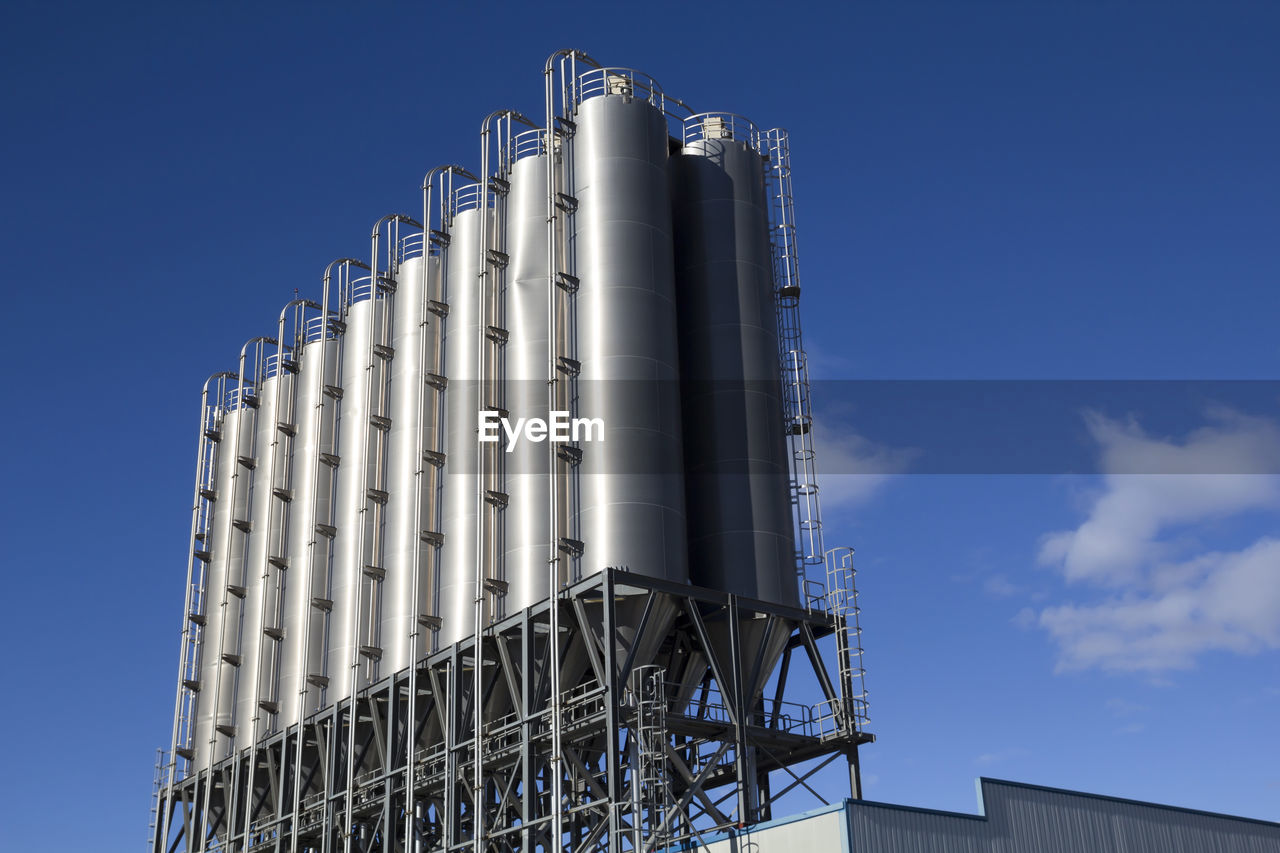 architecture, sky, built structure, tower block, building exterior, industry, skyscraper, blue, low angle view, tower, silo, building, nature, facade, no people, day, factory, business, metal, outdoors, clear sky, city, alloy, landmark