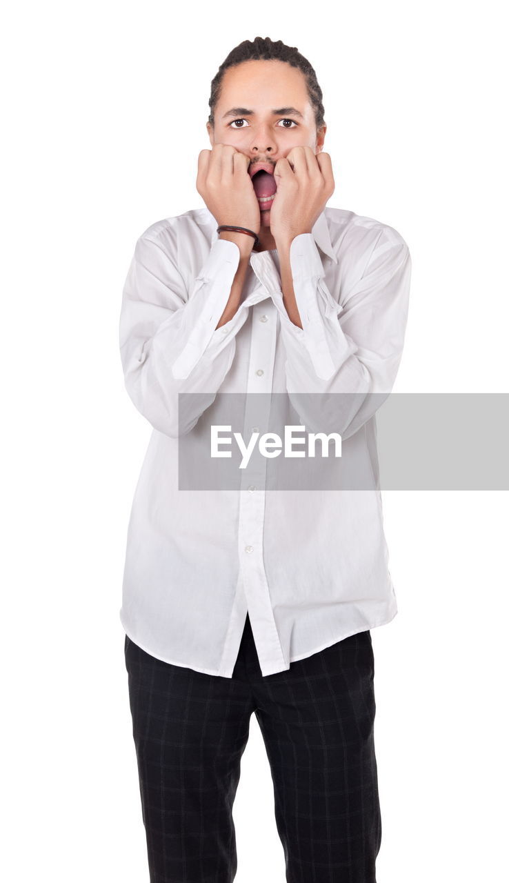 white background, one person, studio shot, clothing, adult, negative emotion, emotion, frustration, emotional stress, cut out, indoors, portrait, men, shock, surprise, overworked, mouth open, facial expression, finger, worried, young adult, front view, business, communication, hand, businessman, sadness, person, dress shirt, human mouth, white, anxiety, standing, sleeve, outerwear, head in hands, irritation, shouting, displeased, casual clothing, headache, button down shirt, relaxation, distraught, looking at camera, uncomfortable, trousers, looking, three quarter length, white-collar worker, human face, disappointment, medical