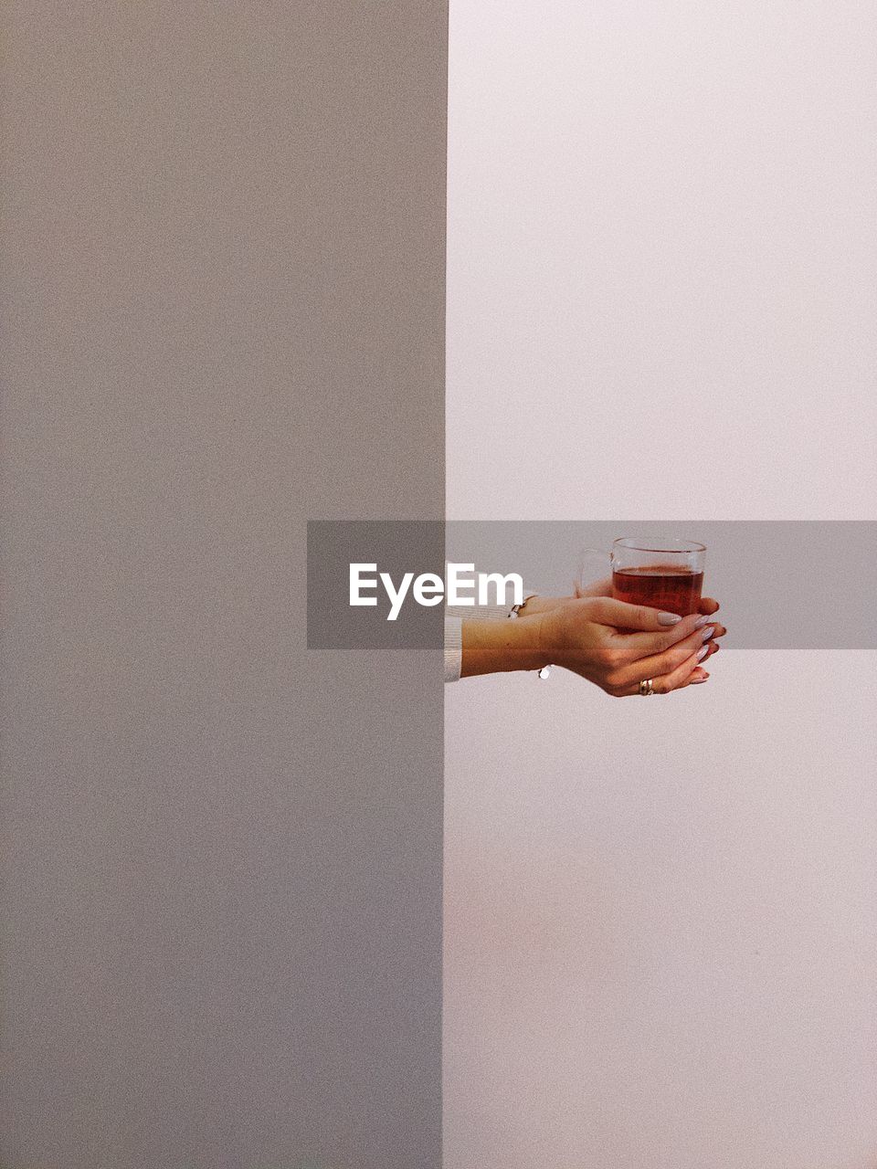 Cropped hands of woman holding coffee cup