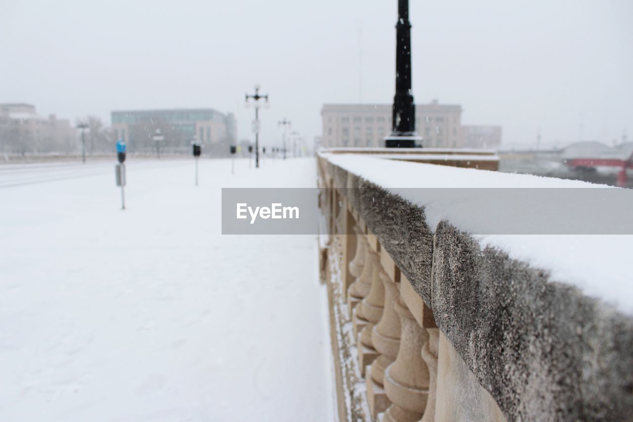 SNOW COVERED BUILT STRUCTURE AGAINST SKY