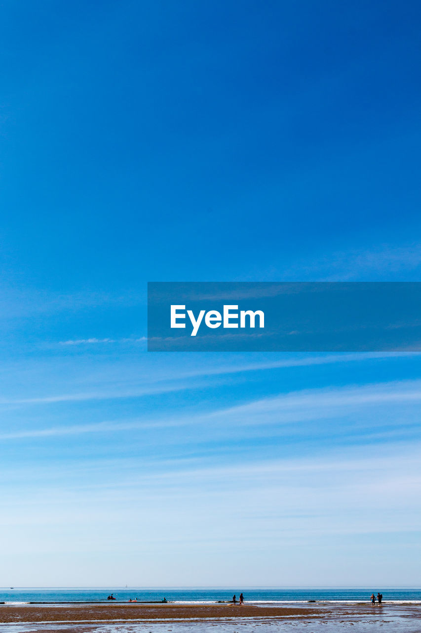 SCENIC VIEW OF BEACH AGAINST BLUE SKY