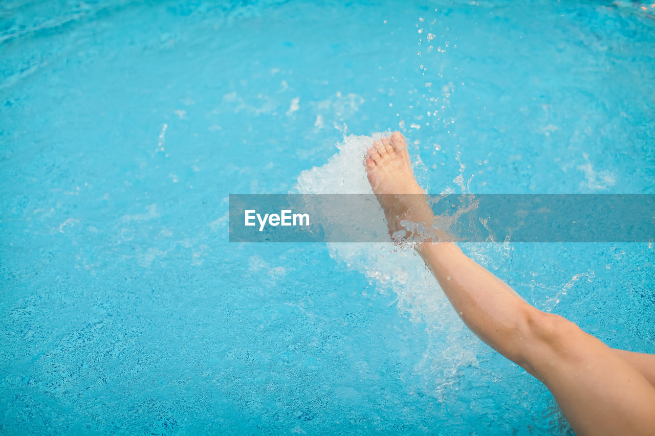 Low section of woman in swimming pool
