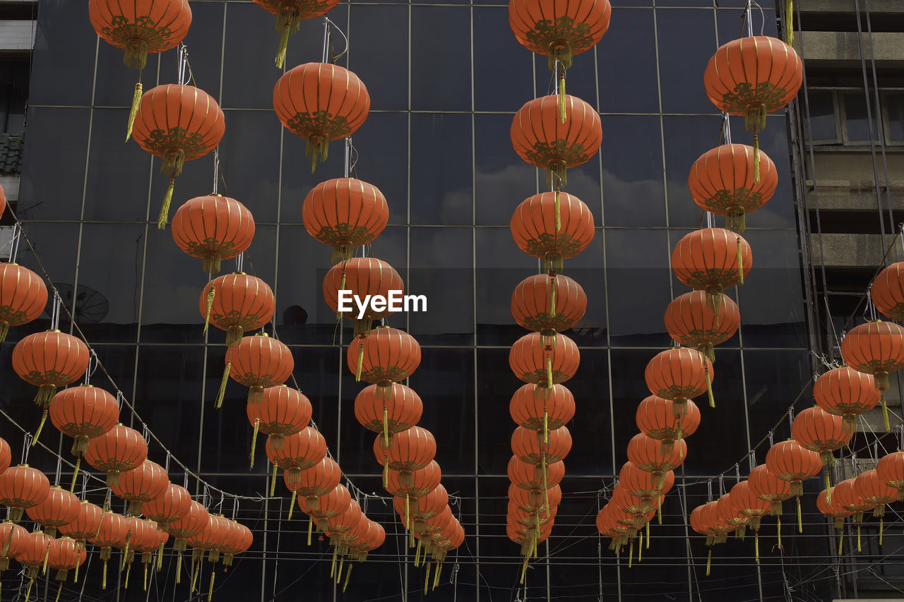 Low angle view of lanterns hanging against building