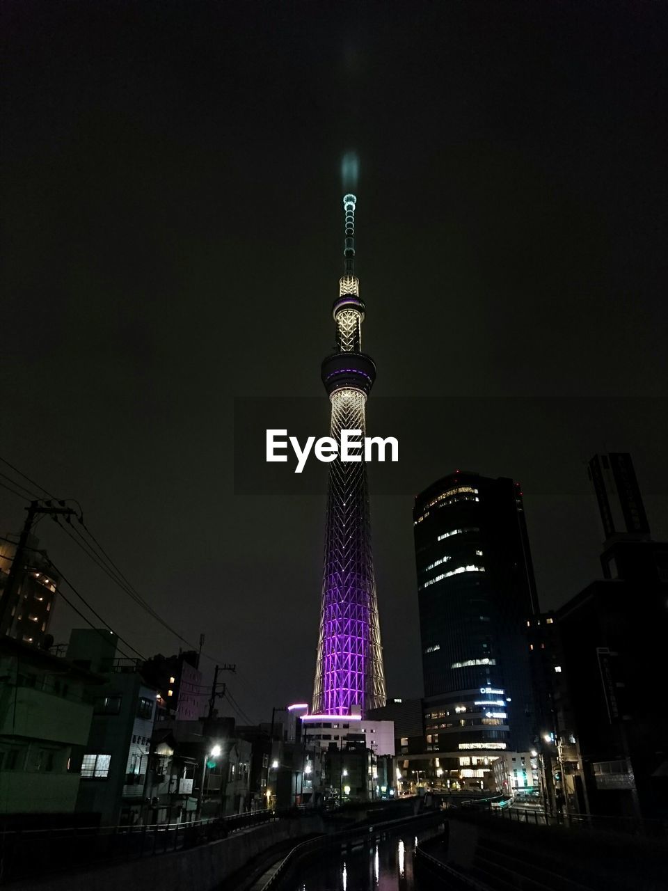 Low angle view of illuminated tower at night
