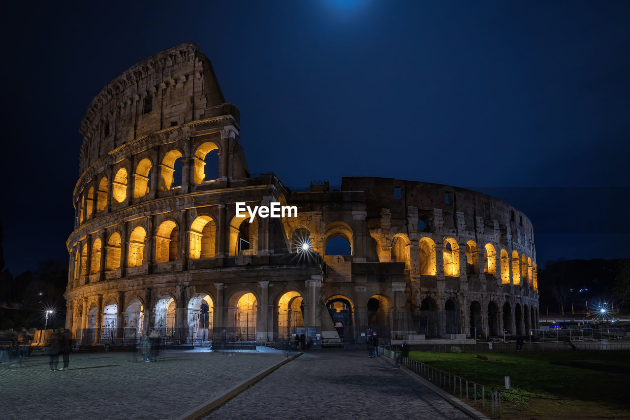 Illuminated colosseum at night, long exposure.