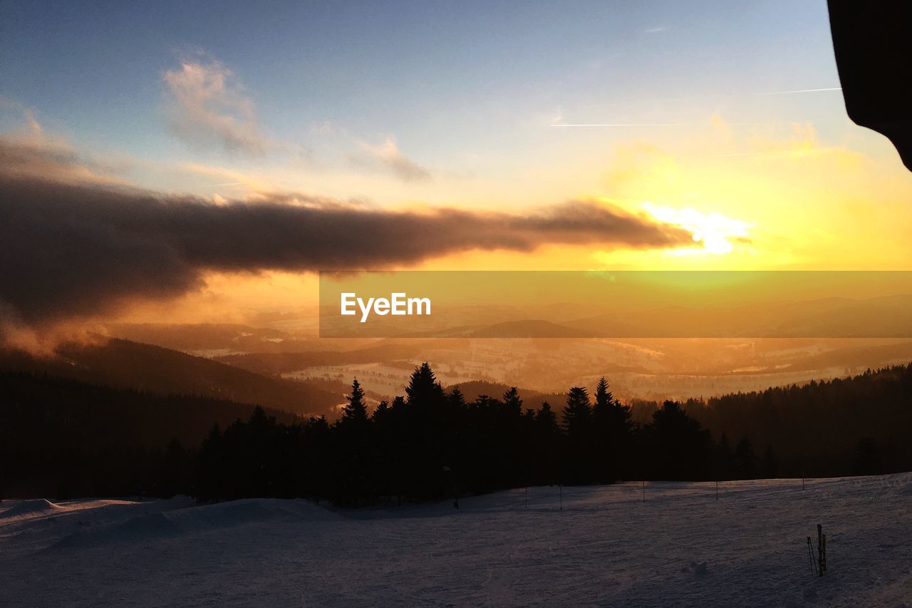 SCENIC VIEW OF MOUNTAINS DURING SUNSET