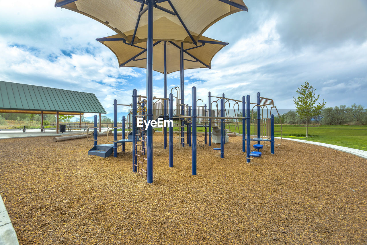 EMPTY PLAYGROUND AGAINST SKY