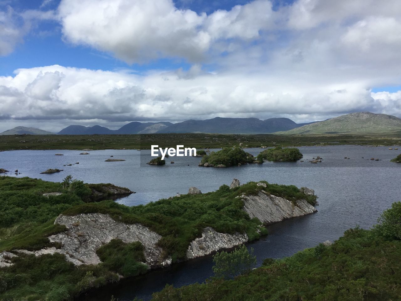 Scenic view of river and mountains against sky