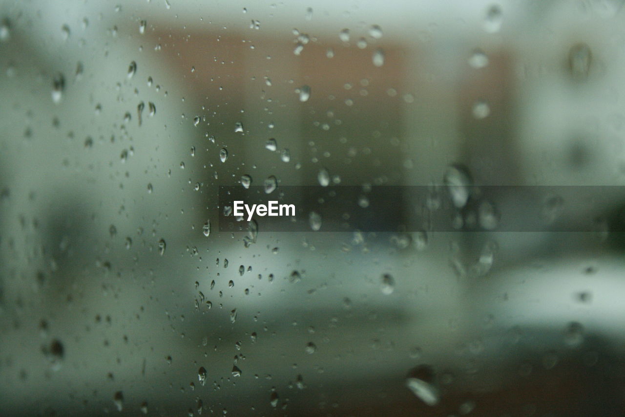 CLOSE-UP OF WATER DROPS ON WINDOW